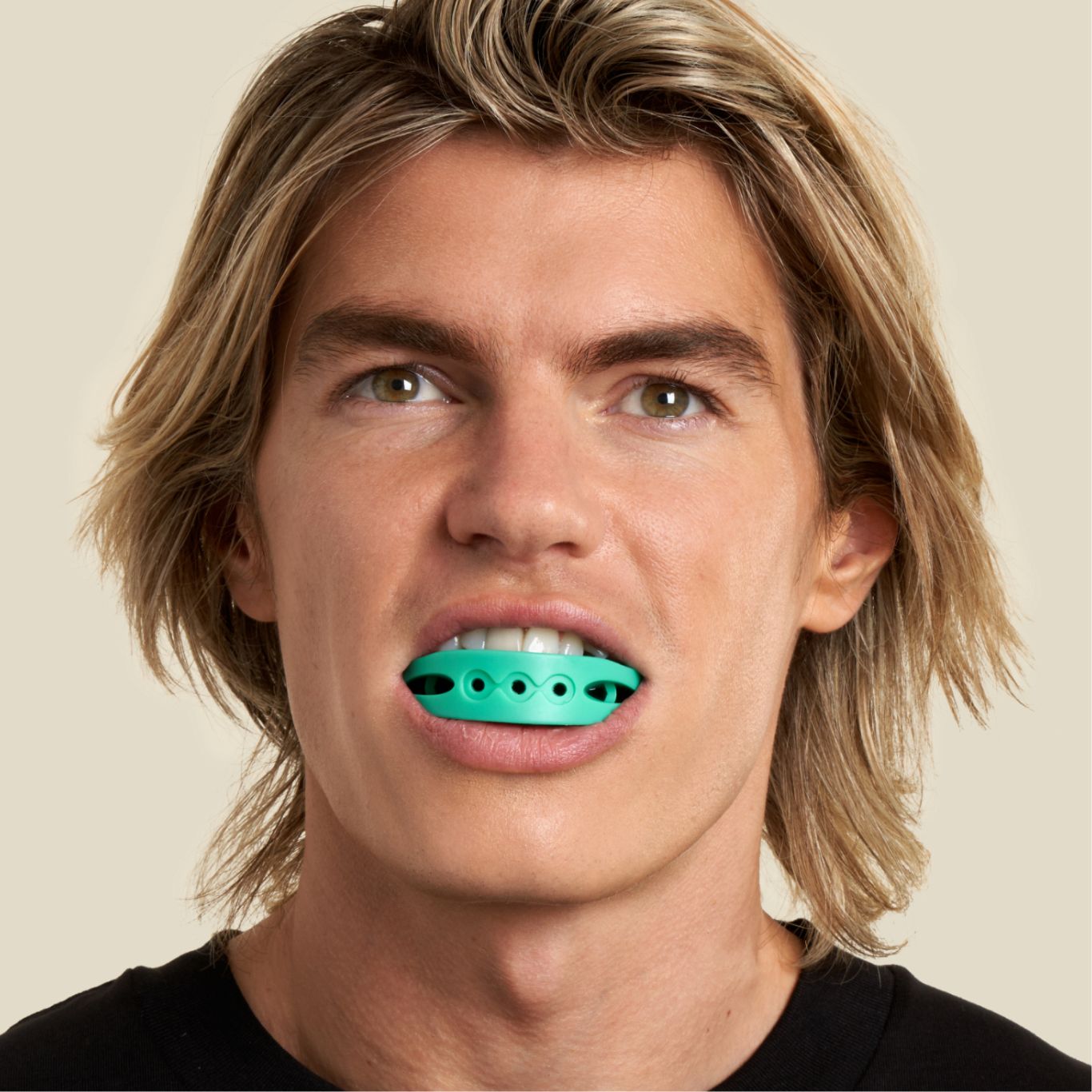 Man has a green full face trainer in his mouth