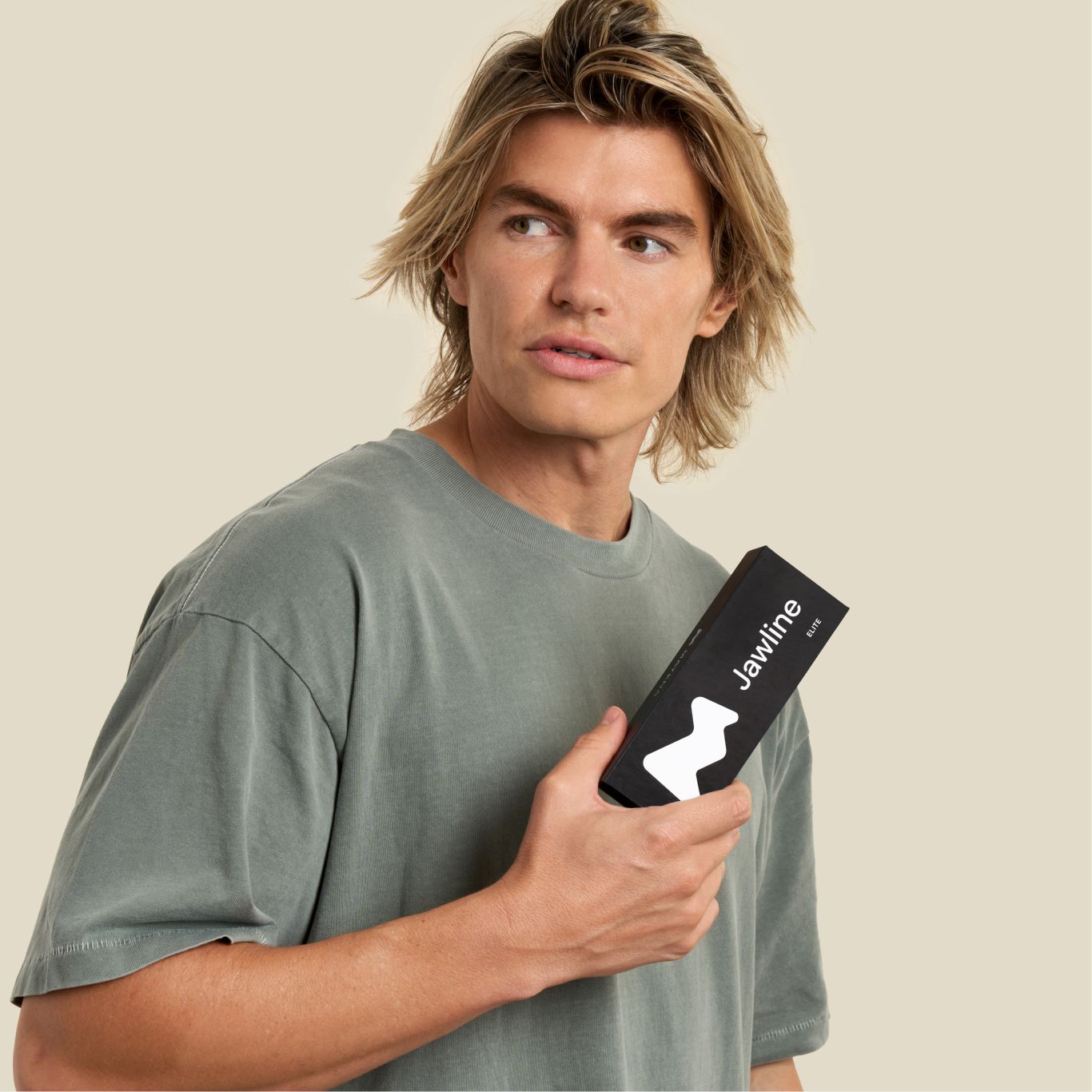 Sharp jawline man holding a jawline elite package