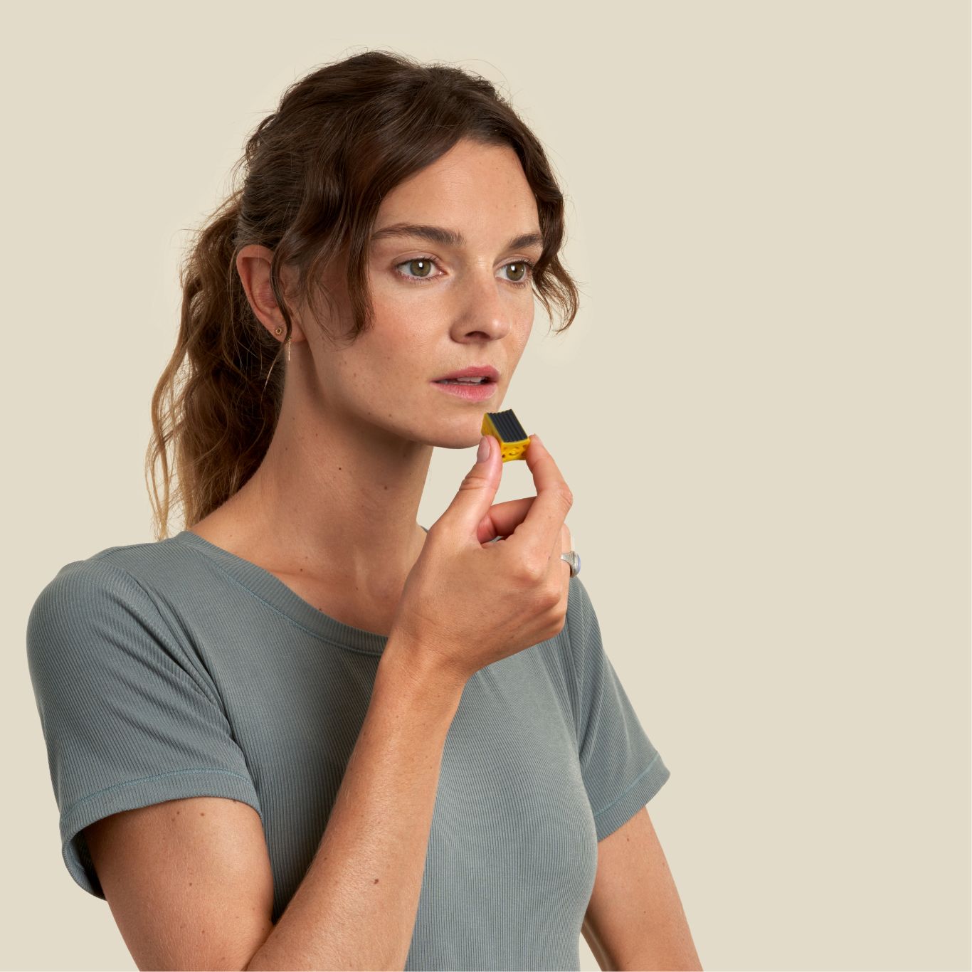 Sharp jawline woman holding a jawline core prior to face exercising