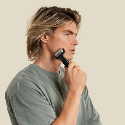 man using ice roller post facial exercise to sooth his muscles