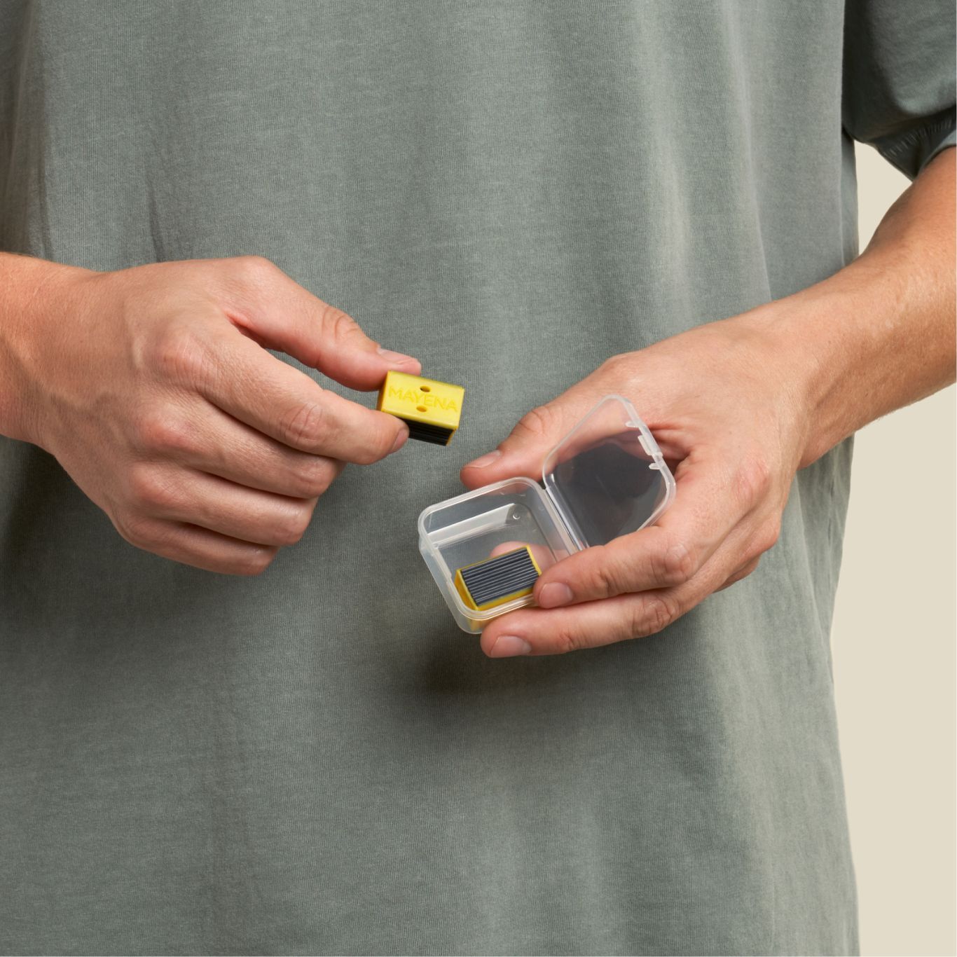 man removing jawline core yellow pair from its container