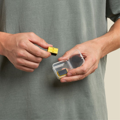 man removing jawline core yellow pair from its container