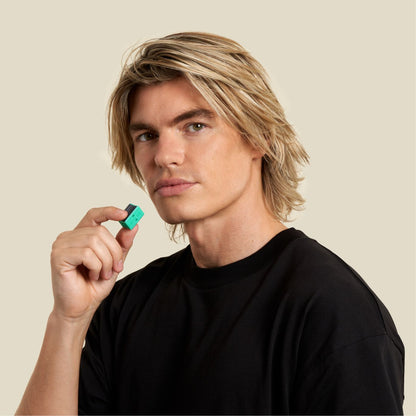 Sharp jawline man holding a jawline core prior to face exercising