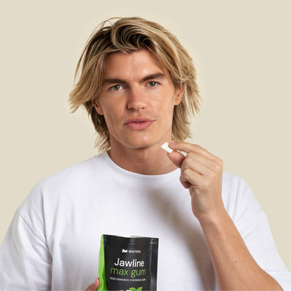 Man holding Jawline max gum packaging and a gum in display in hand